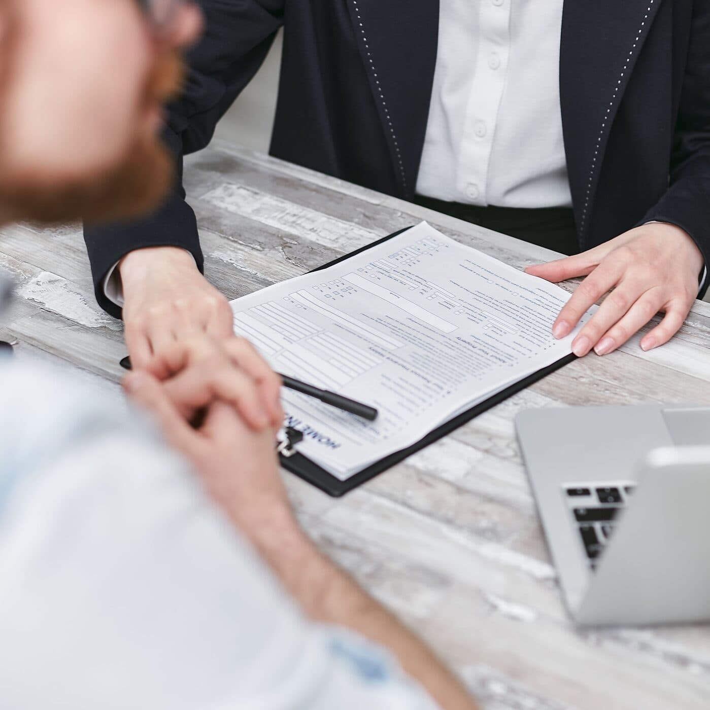 Two people reviewing a written proposal together at a desk