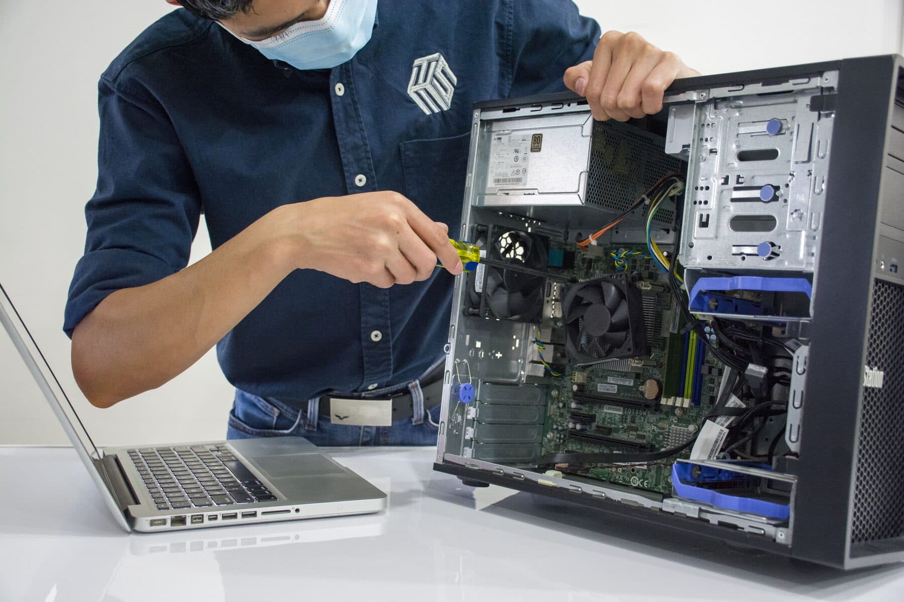 A technician inspecting components inside a desktop computer